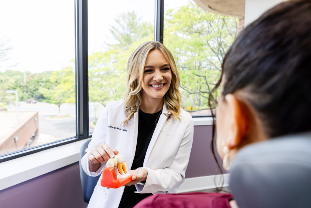 A dentist in Fairfax explaining to a patient how dentures work.