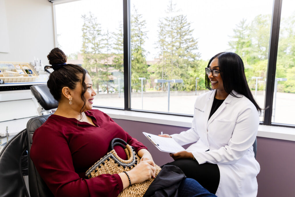 Dentist talking to a patient about dental cleaning in Fairfax, VA.